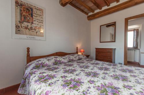 a bedroom with a bed and a dresser and a window at Sant'Antonio in Volterra