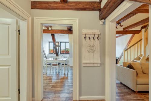 a hallway with a dining room with a table at Ferienwohnungen Steinweg 61 in Quedlinburg