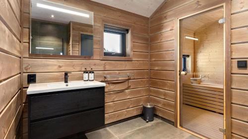 a bathroom with a sink and a mirror at Gandalv Hytte - 8p - With Sauna & Hot Tub in Vradal