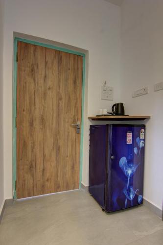 a door to a room with a purple refrigerator at Comfort Holiday Home in Baga