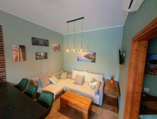 a living room with a couch and a table at Casa Bonita 2 Bedroom apt with the Best view in Town! in Paleros