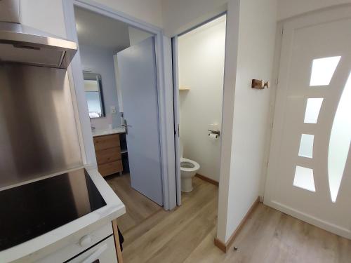 a bathroom with a toilet and a sink at Le merle enchanté in Mons-en-Chaussée