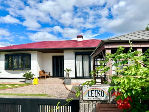 a white house with a red roof at 弓ヶ浜海水浴場徒歩1分! 一棟貸別荘! Yumigahama Beach House & BBQ! in Minamiizu