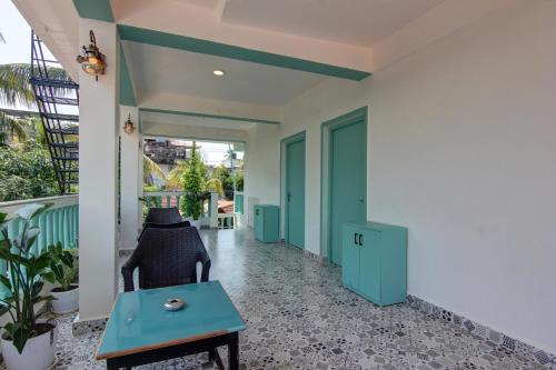 a hallway with blue doors and a table at Comfort Holiday Home in Baga