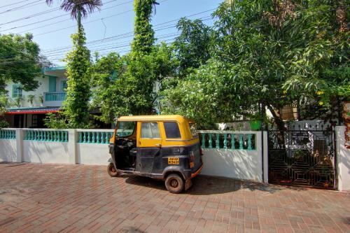 a small car parked next to a fence at Comfort Holiday Home in Baga