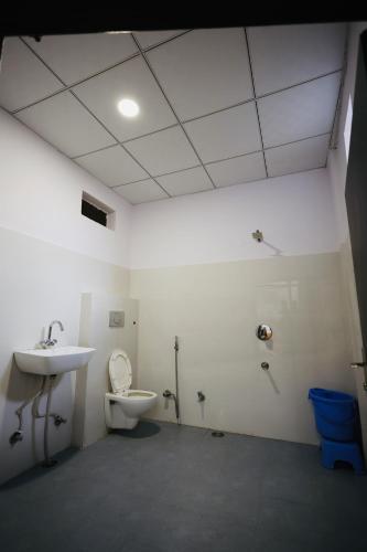 a bathroom with a toilet and a sink at HOTEL SHIVIKA in Bikaner