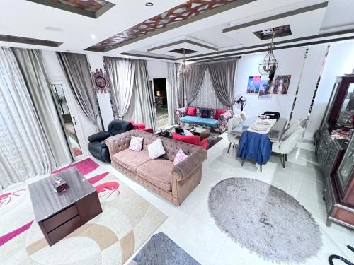 a living room with a couch and a table at Villa Contenental residense El sheikh Zayed Beverly Hills in Sheikh Zayed