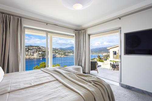 a bedroom with a large bed and a large window at Villa Mimosa in Andratx