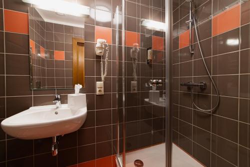 a bathroom with a sink and a shower at Comfort Hotel Kuldiga in Kuldīga
