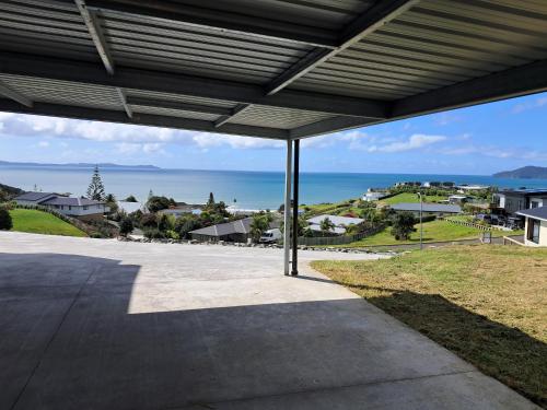 an empty patio with a view of the ocean at The King's Keep in Cable Bay