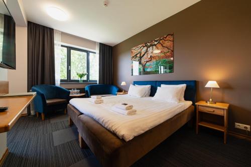 a hotel room with a bed and a desk at Comfort Hotel Kuldiga in Kuldīga