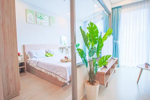 Postel nebo postele na pokoji v ubytování Dứa's House - The Sóng Vũng Tàu, Sky Pool & Gym