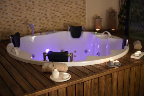 a bath tub with two chairs in a room at Radisson Hotel Mersin in Mersin