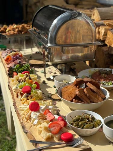 a table topped with lots of different types of food at Chalupa Hejmovka in Špindlerův Mlýn