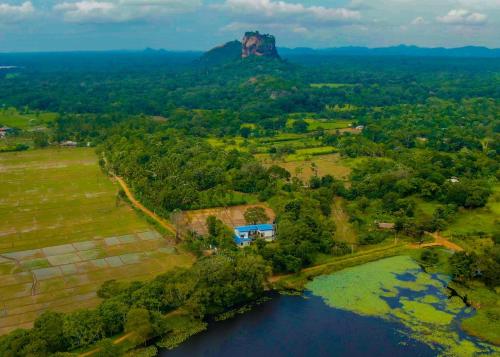 an aerial view of a mountain and a river at Bungalow Resort - Sigiriya in Sigiriya