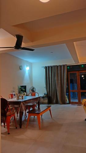 a living room with a table and a couch at Luxury Villa Ganga Kutir in Raichak
