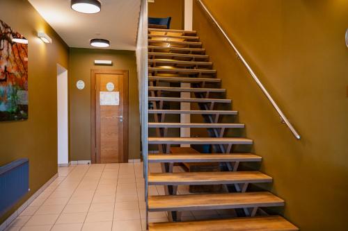 a set of stairs in a hallway with a door at Comfort Hotel Kuldiga in Kuldīga