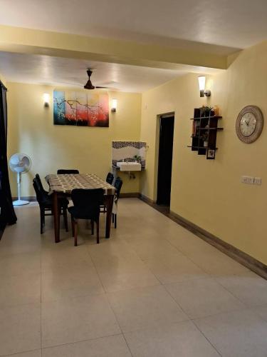 a dining room with a table and chairs and a clock at Luxury Villa Large Private Pool in Raichak