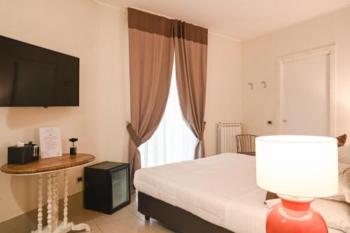 Ένα ή περισσότερα κρεβάτια σε δωμάτιο στο Relais Palazzo Duomo B&B