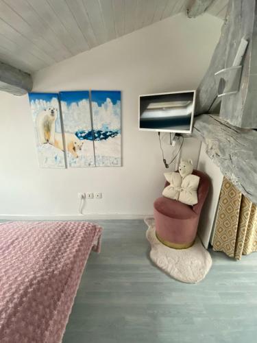a bedroom with a doll sitting in a chair at B&B Insolite entre Lyon et aéroport in Pusignan