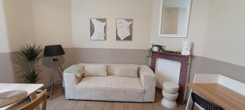 a living room with a couch and a table at Au Coeur de LilleMoulins in Lille