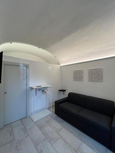 a living room with a couch and a glass door at B&B Piccola Stella in Pisa