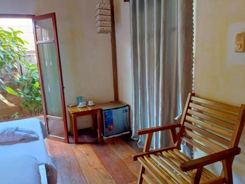 a living room with a tv and a wooden floor at Ireenkevin guesthouse in Luang Prabang