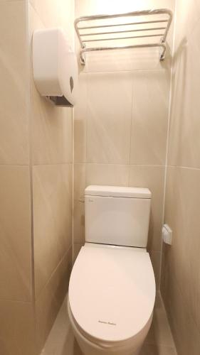 a bathroom with a toilet and a roll of toilet paper at OYO Hostel Myeongdong 6 in Seoul