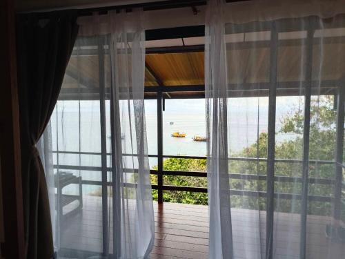 a room with a window with a view of the water at Nangyuan Island Dive Resort in Koh Tao
