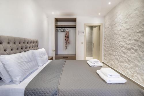 a bedroom with a bed with two towels on it at Gkountis Garden Studio in Tsoukaladhes