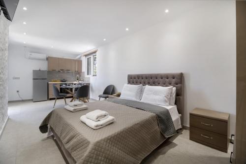 a bedroom with a bed with two towels on it at Gkountis Garden Studio in Tsoukaladhes