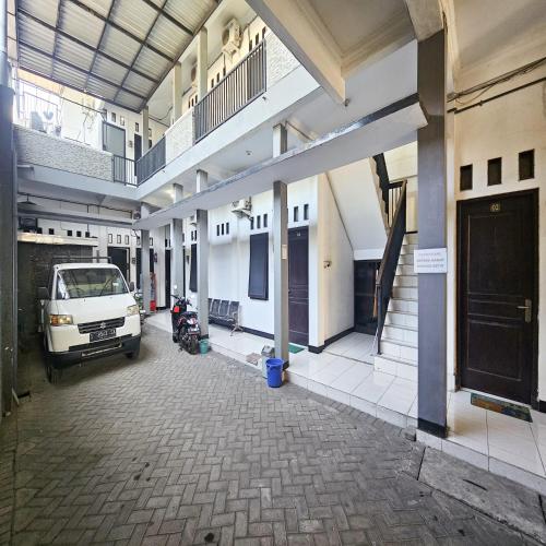 a van parked in a building with a parking lot at Ijen Homestay Mojokerto RedPartner in Mojokerto