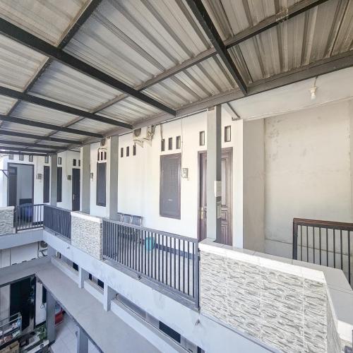 an empty building with a balcony with a roof at Ijen Homestay Mojokerto RedPartner in Mojokerto
