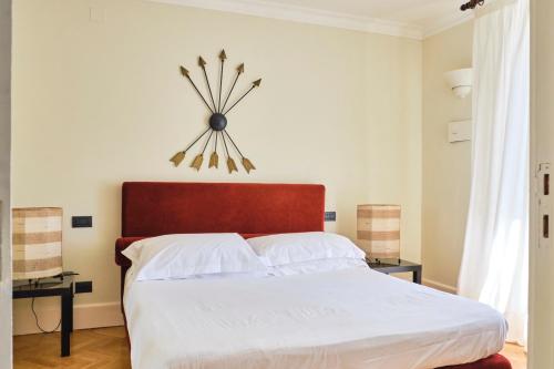 a bedroom with a large bed with a clock on the wall at Casa Rubinacci in Naples