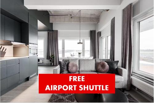 an apartment with a couch and a kitchen with text free airport shuttle at Forenom Hotels & Apartments Arlanda in Arlanda