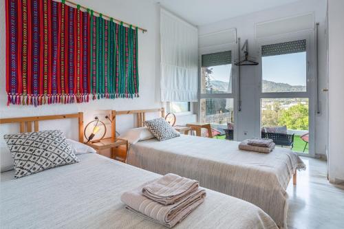 a bedroom with two beds with towels on them at Torre Mirador Azul 2 habitaciones in Tossa de Mar
