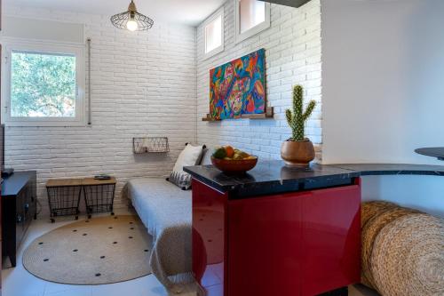 a living room with a red cabinet and a couch at Torre Mirador Azul 2 habitaciones in Tossa de Mar