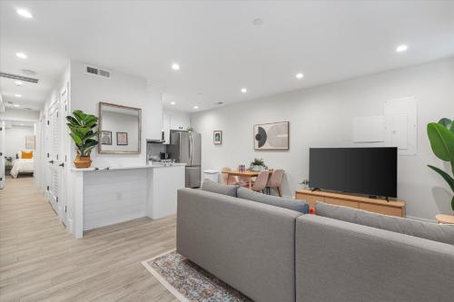 a living room with a couch and a tv at Central 2-BR City Sanctuary - Commuter-Friendly in Washington, D.C.