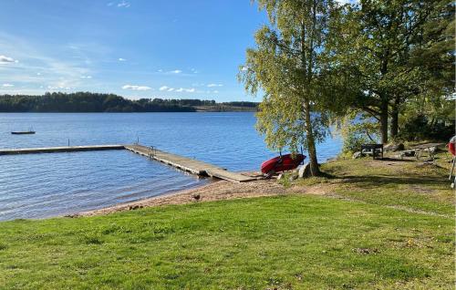 a dock on the shore of a large lake at Cozy Home In Tranås With Lake View in Tranås