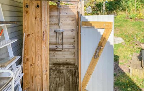 a wooden shower with a door in a backyard at Cozy Home In Tranås With Lake View in Tranås