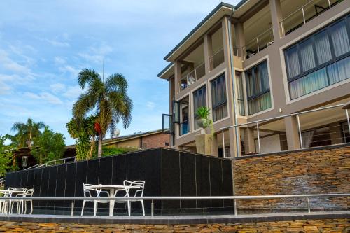 a building with tables and chairs in front of it at Royal Mukumbura Malelane in Malelane