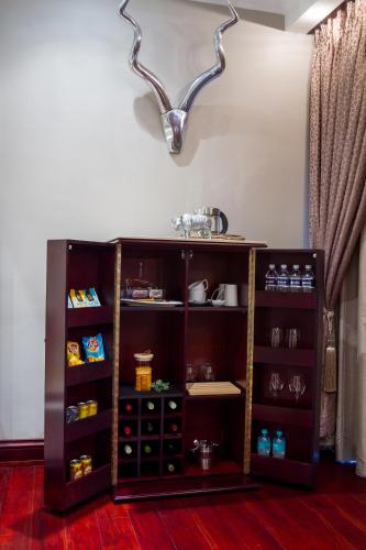 a brown book shelf with food items on it at Royal Mukumbura Malelane in Malelane