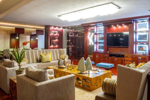 a large living room with couches and a television at Royal Mukumbura Malelane in Malelane