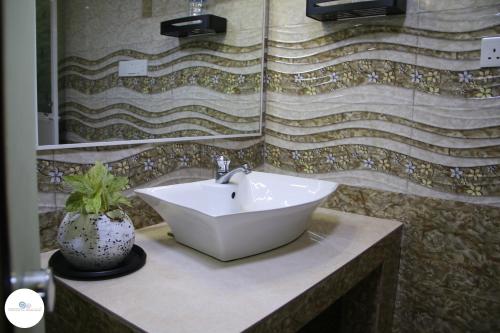 a bathroom with a sink and a mirror at Sawanga Home Stay in Weligama