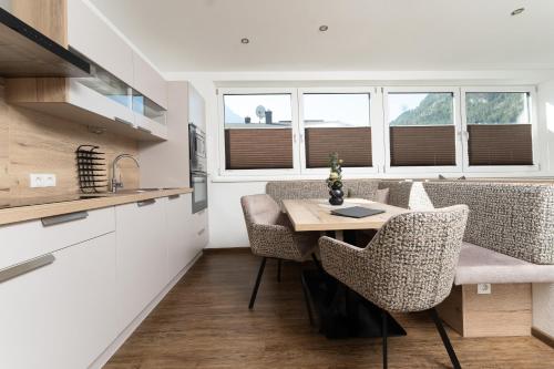 a kitchen with a table and chairs in a room at Appartement Schöpf in Längenfeld