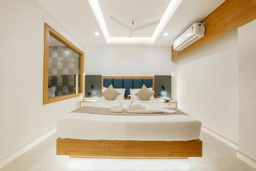 a bedroom with a large white bed in a room at Aurora Hotels and Resorts in Pulickamaly