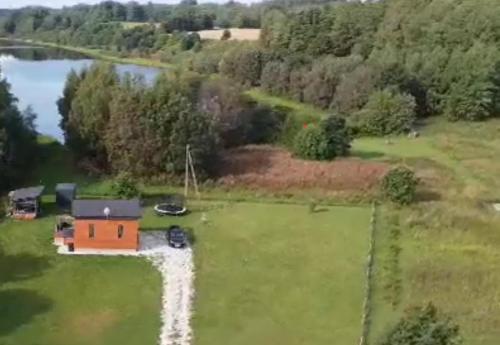 an aerial view of a small house on a grass field at Hurmioru guesthouse near Otepää with sauna in Hurmi