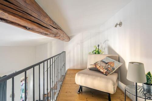 a stairway with a chair and a table at Le Cure in Florence