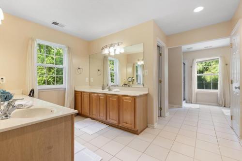 a bathroom with two sinks and a large mirror at Entire 4-BR in Beloved DC Area Takoma Park in Takoma Park