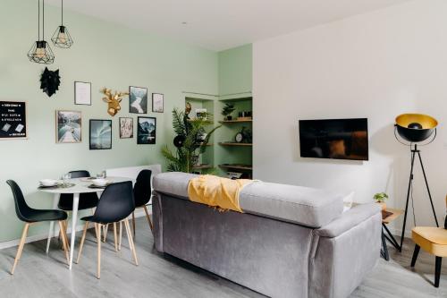 a living room with a couch and a table at La Suite D'Hélène - Appartement - 50m2 entre Genève et Chamonix - Parking Privé - Wifi in Scionzier